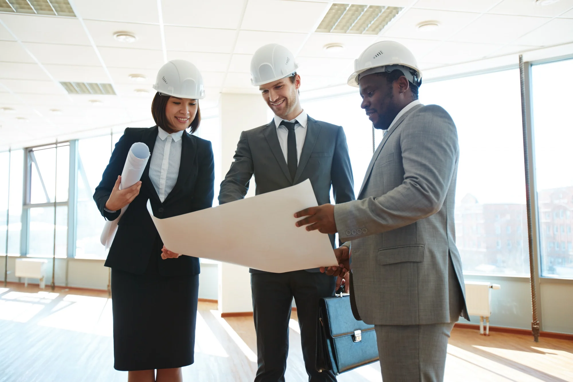 A team of Architects analysing a blueprint.