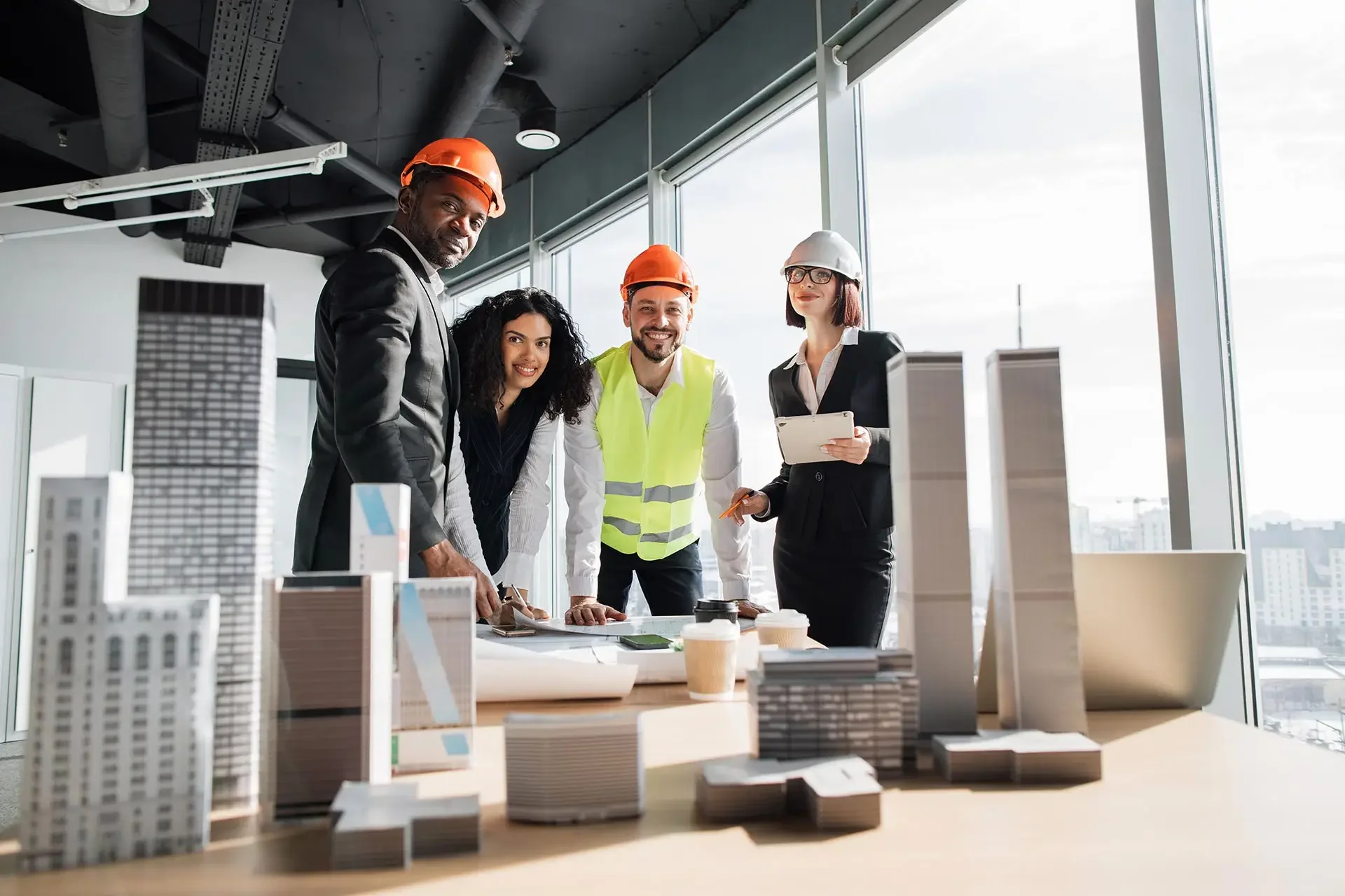 Architects reviewing a building project model in an office setting.