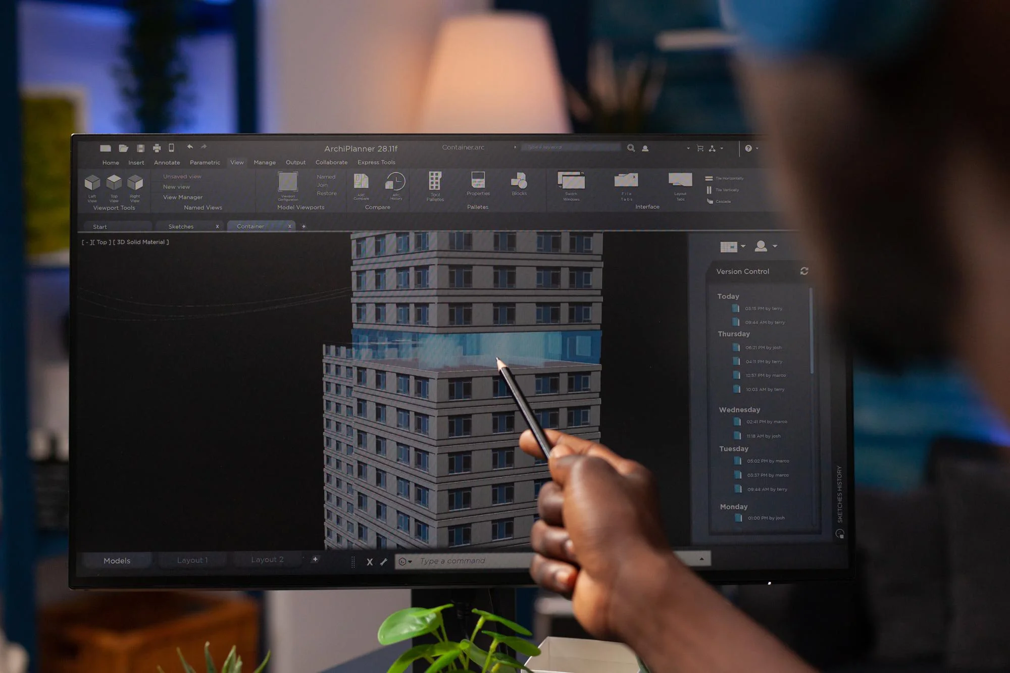 Architect analyzing construction model on computer.