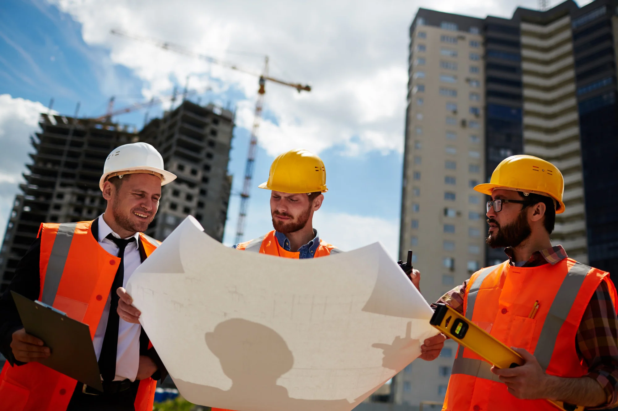 Civil engineers analysing a project sketch onsite.