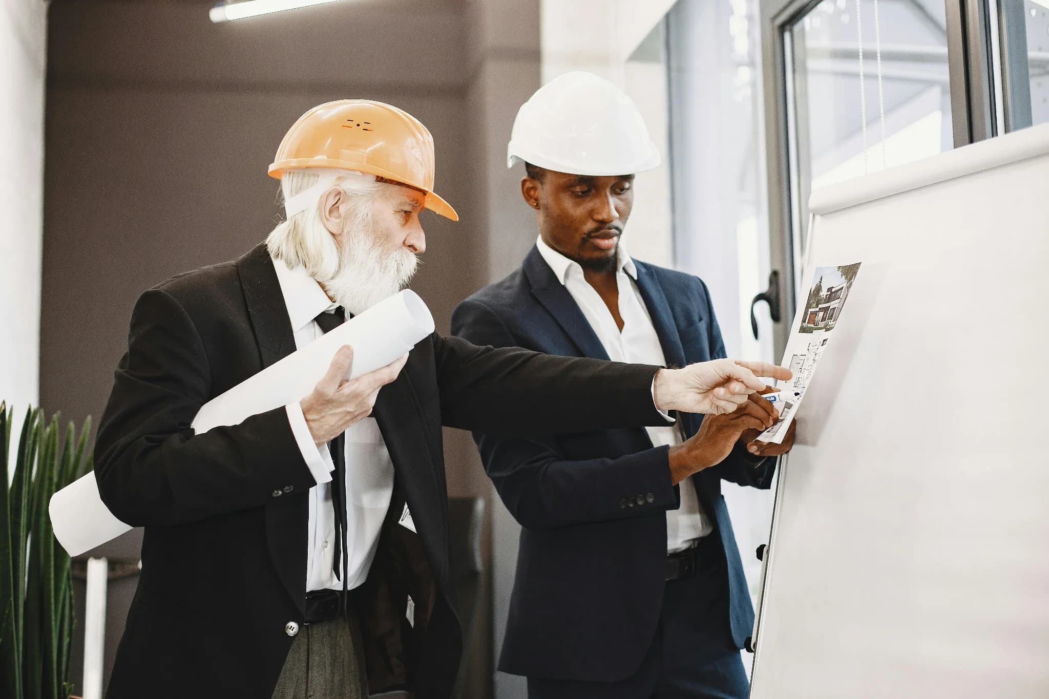 Construction professionals reviewing blueprints.