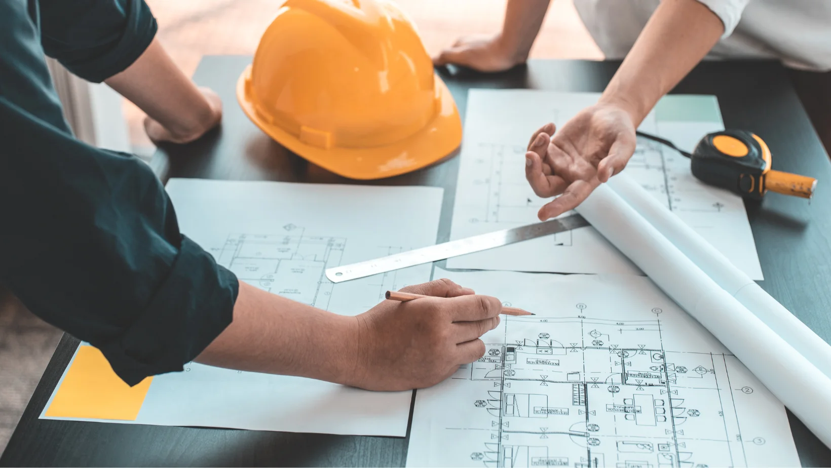 Architects coordinating on the development of blueprints.